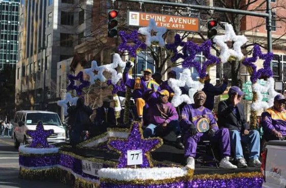 Photo of a purple and white float at the MLK parade on N. Tryon St.