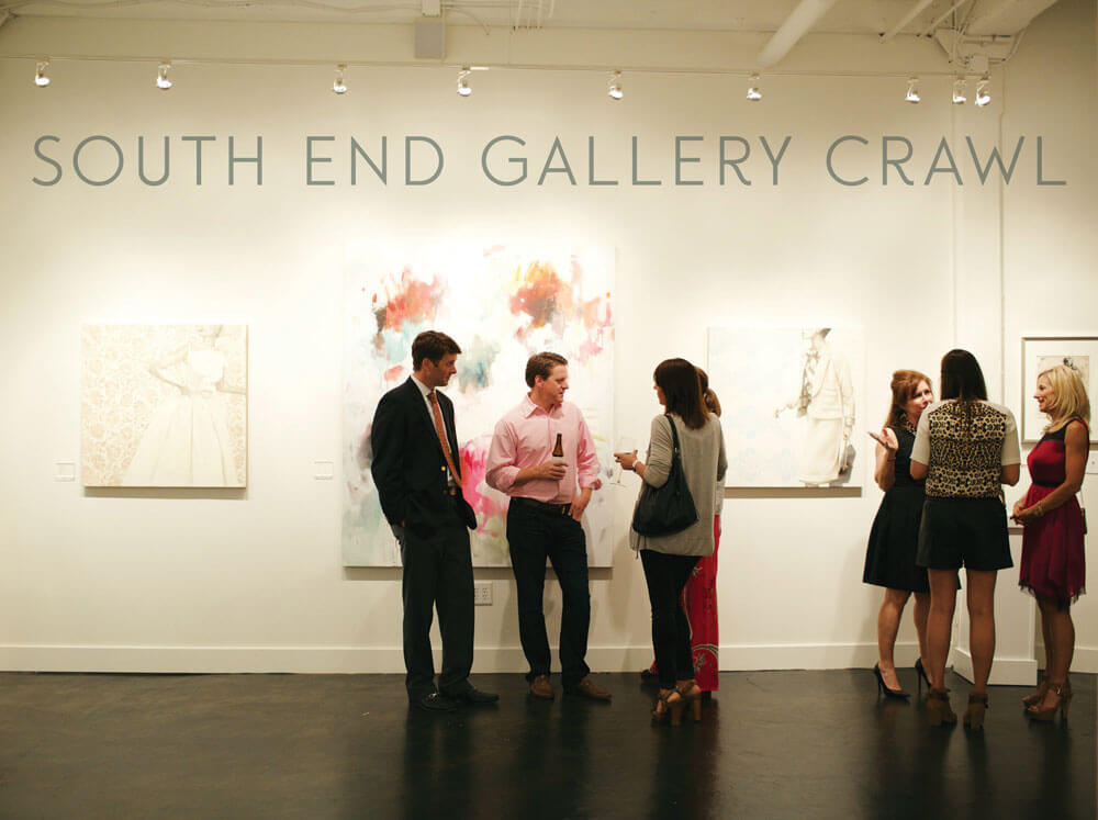 photo of people at an art gallery. Words "South End Gallery Crawl" at top of wall.